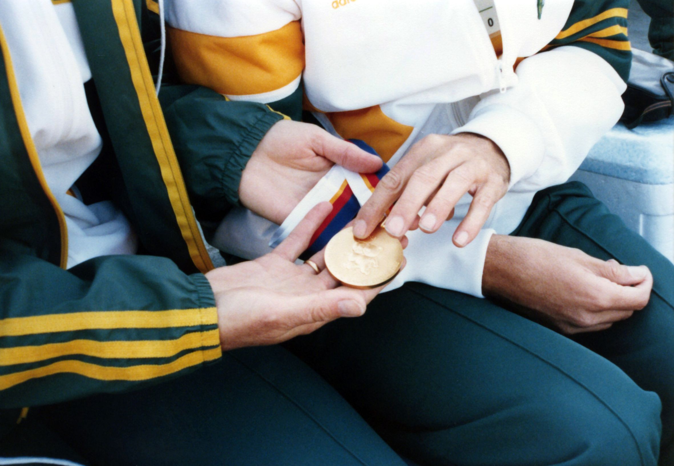 Two Australian athletes holding a gold medal at the 1988 Seoul Paralympic Games.