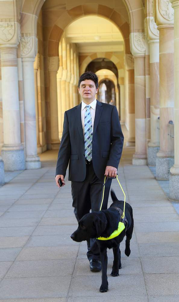 Associate Professor Paul Harpur with his late dog Chester in UQ&#39;s Great Court.