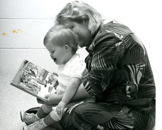 Program participant Hollie Symons reading with her mum