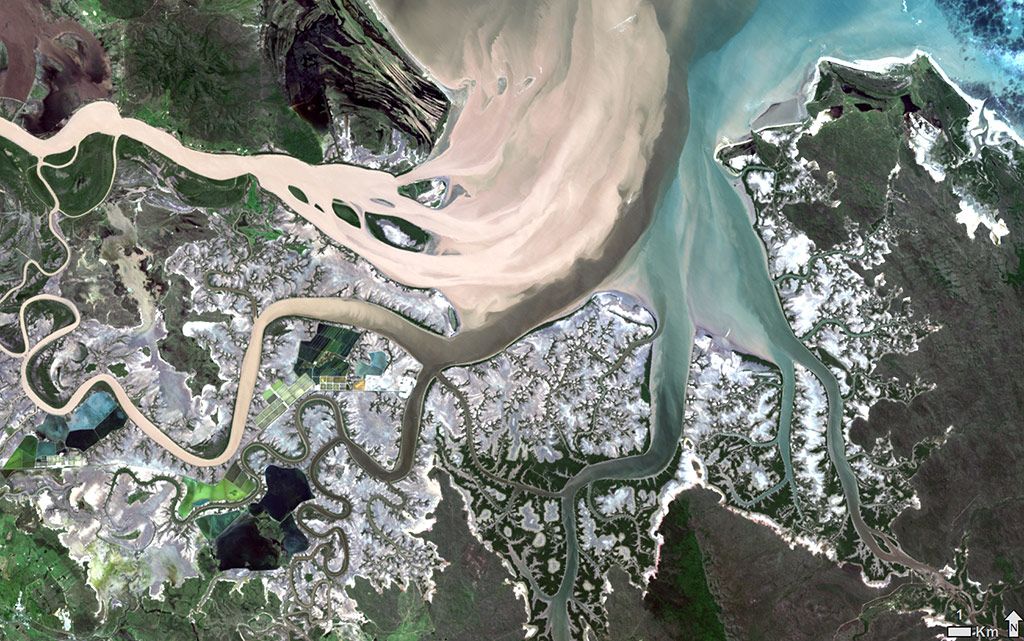This ‘natural colour’ Landsat 8 image shows sediment-laden floodwaters of the Fitzroy River (Toonooba) flowing through the Fitzroy Delta and into the Coral Sea, east of Rockhampton in Central Queensland. The muddy waters are tan coloured, strongly contrasting with the less turbid blue and green waters of Connor Creek and Deception Creek.