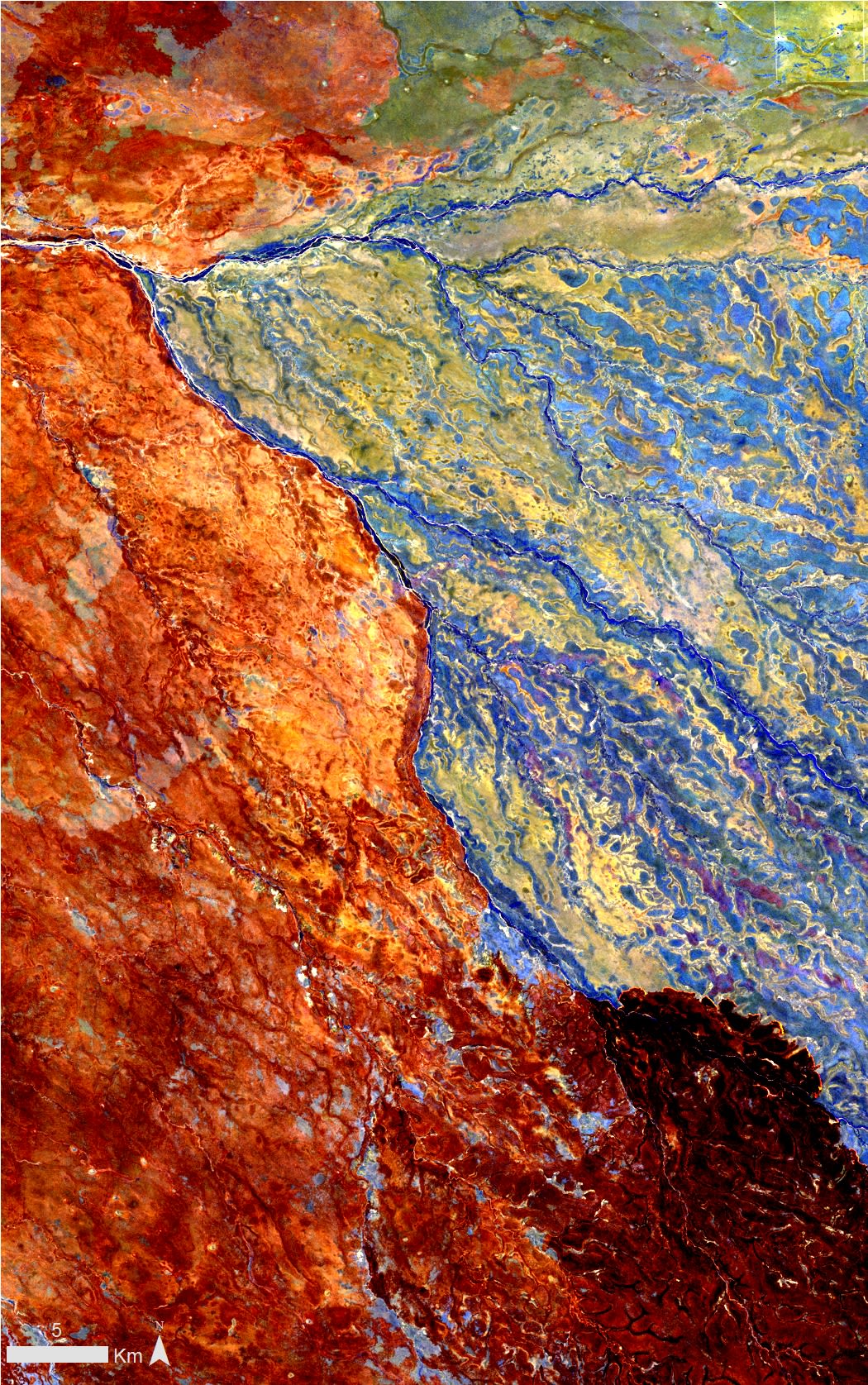 This false colour Landsat 8 image shows a recent fire burning across Staaten River National Park and nearby properties in northern Queensland. The darker red area in the lower right of the image has been recently burnt, with thin bright red lines showing the active fire front. The orange-red area on the left of the image was burnt as the fire travelled from the west to the east, during late October and November. The Staaten River, running from the top left of the image to the lower right corner, has acted as a partial barrier to the fire. Unburnt vegetation is shown in blue and light green on the right side of the image.