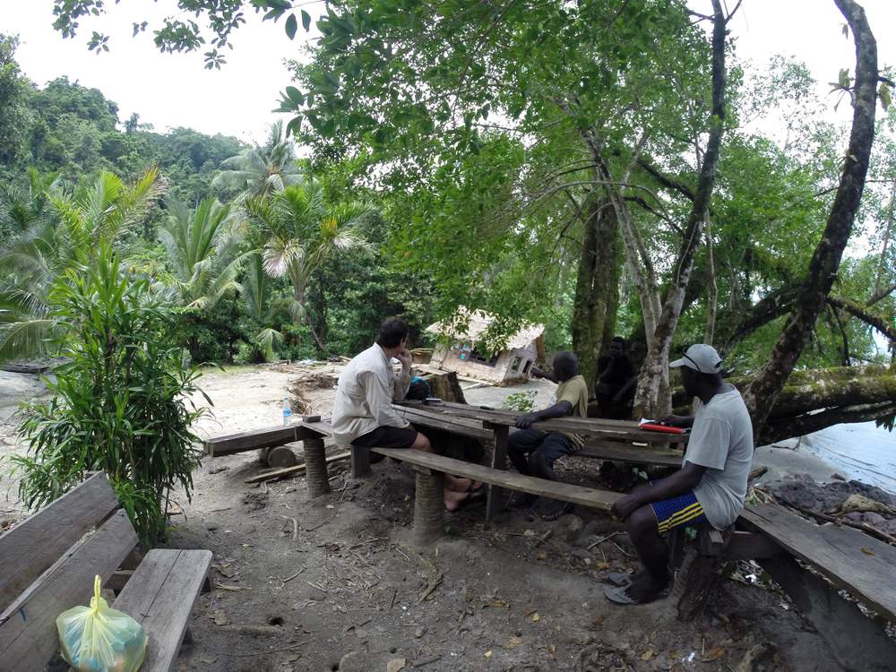 Dr Albert discusses relocation options with a displaced Nuatambu Island resident whose house was washed into the sea.