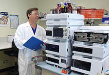 a researcher checks the hplc system on a bench