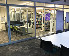 desks, chairs and glass doors with rooms in background