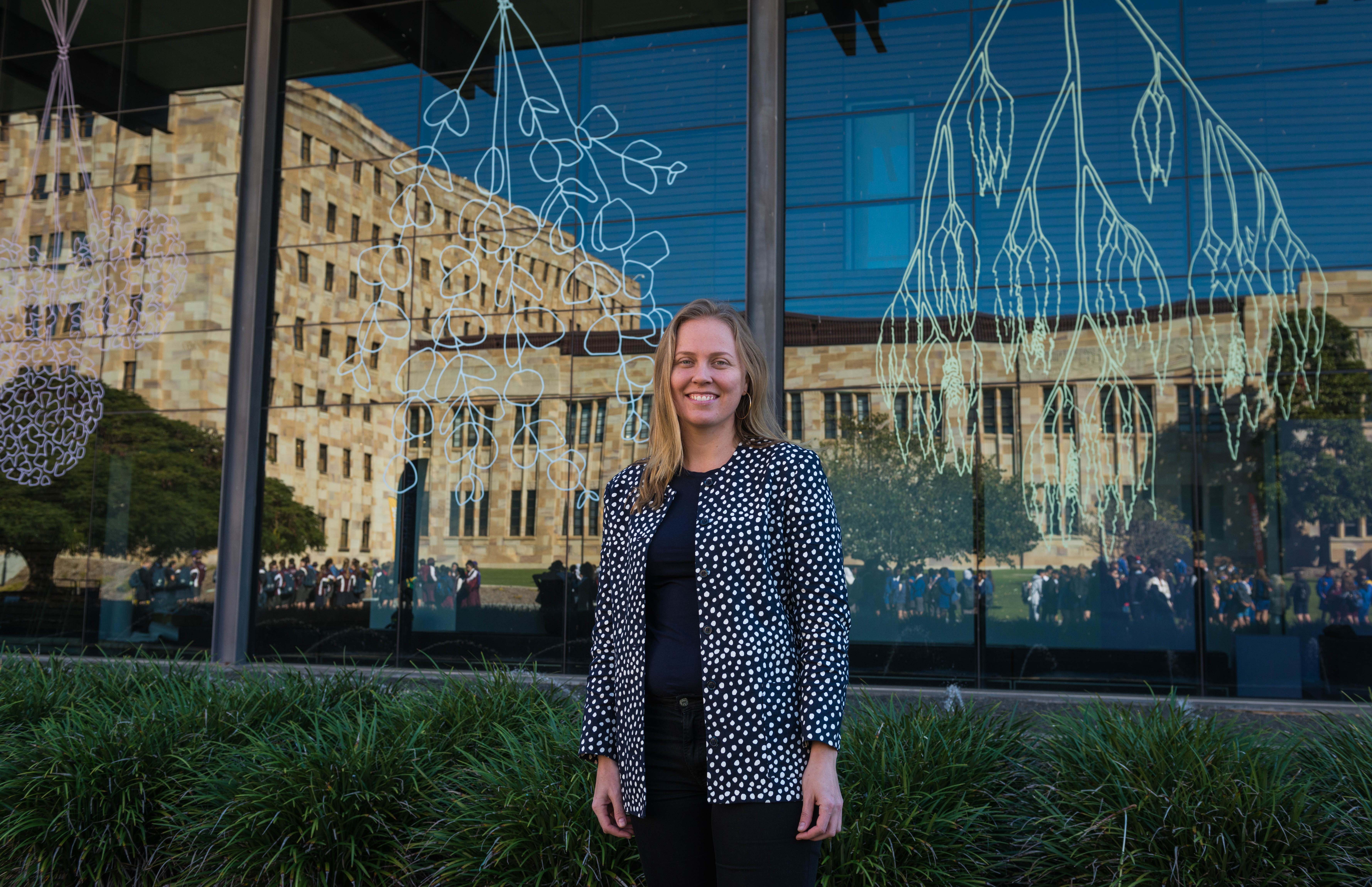 Artist Elizabeth Willing with her commissioned design on the front of the UQAM