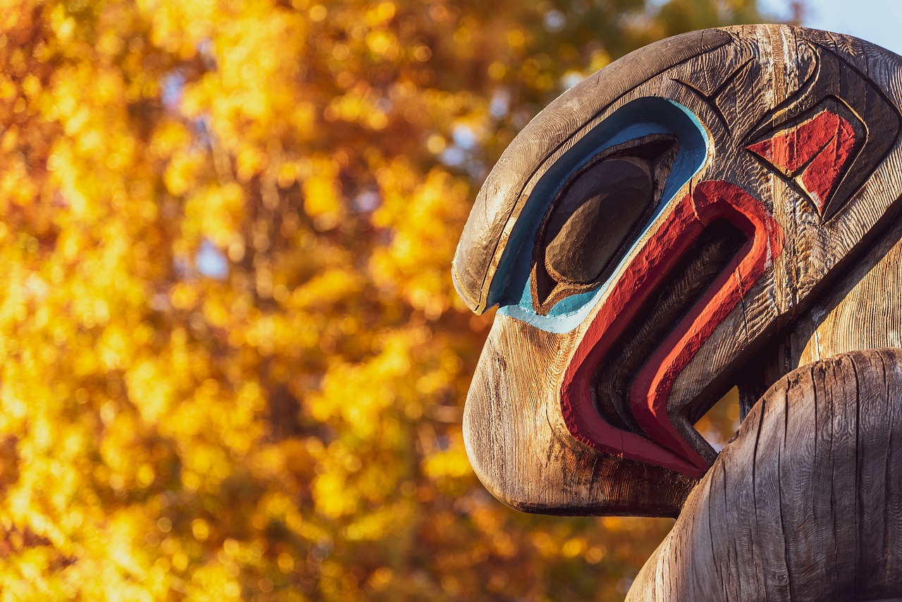 First Nations totem against an autumn tree