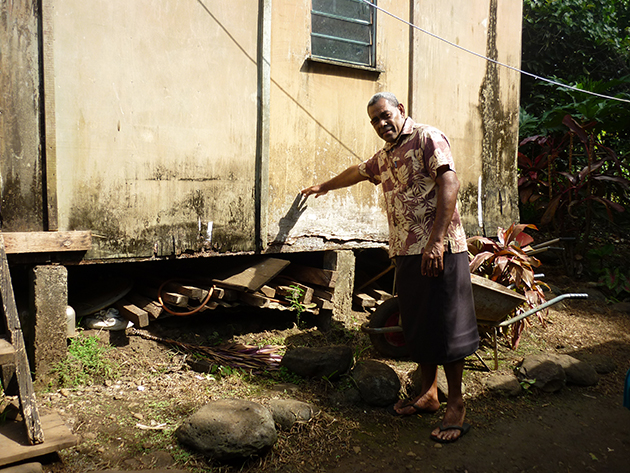 Turaga-ni-Koro (village headman) shows us where the last flood reached homes in Qeleni village, Taveuni, Fiji. (Credit: Karen McNamara)