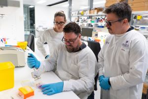 Three scientists working in a lab. Image, UQ