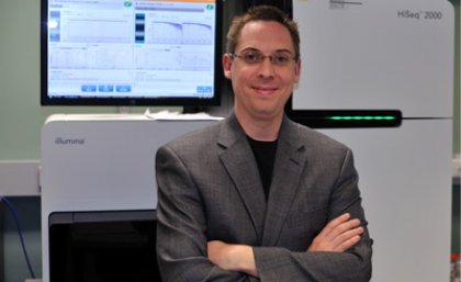 Dr Ryan Taft with an Illumina sequencer, on which the gene sequencing was performed.
