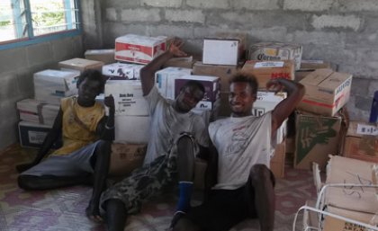 Avu Avu locals helped carry the shipment of books up to the school.