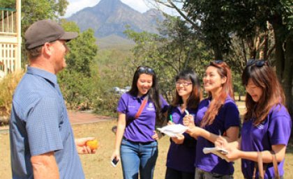 Students Amy Yuchen Li, Joanne Fang, Crystal Ip and Cici Chan talk to a local business operator. Photo by Brent Randall