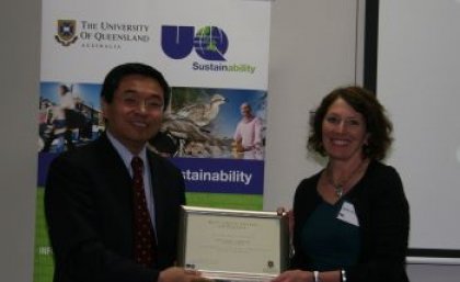 Jenny Hall of the UQ Dentistry Library receives an award for the Best Green Office Initiative from Senior Deputy Vice-Chancellor Professor Max Lu. Photo: Stuart Green