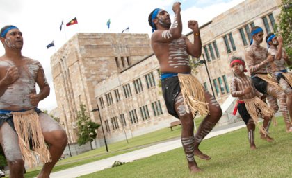 Nunukul Yuggera Aboriginal Dancers perform in front of the newly raised flags