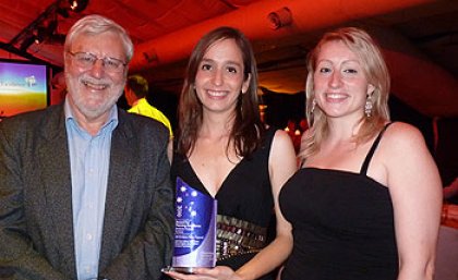 Professor John Minnery with winning students Isabel Ceron Castano and Heather Lopez