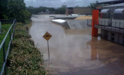 Floodwaters over Glasshouse Road at UQ's St Lucia campus. Picture: Geoff Dennis.