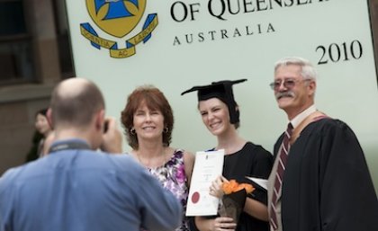 UQ graduates taking family photos in front of the new plinths following graduation ceremonies at the St Lucia campus.