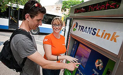 TransLink representative Jessica Brown helps Bachelor of Science student Joshua Horsley use the machine