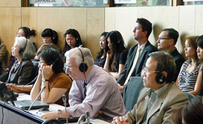 Guests listen to live interpreting in Japanese and Chinese at the opening of the newly refurbished JM Campbell Conference Facility