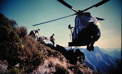 Commander Luckin takes part in a rescue at 10,000 feet in the Drakensberg Mountains, South Africa. With nowhere to land, the pilot has balanced the helicopter on one wheel on a rock Commander Luckin takes part in a rescue at 10,000 feet in the Drakensberg Mountains, South Africa. With nowhere to land, the pilot has balanced the helicopter on one wheel on a rock