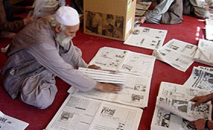Hand-compiling the Kabul Weekly newspaper. 
© UNESCO/M.Hadlow.