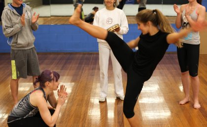 UQ Sport staff participate in capoeira, a type of Brazilian martial art