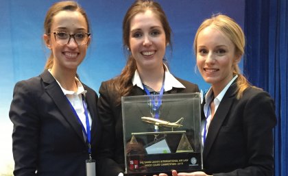 UQ law students, from left, Ella Rooney, Georgina Morgan and Amina Karcic with their trophy   