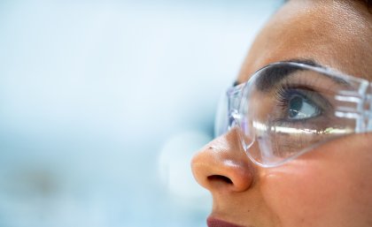 A female engineer wears protective eye wear