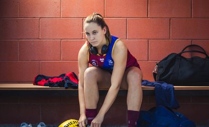 Grider laces up her boots in the change rooms.