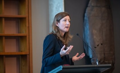 Professor Nicole Gillespie speaking at a podium