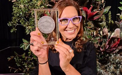Image: Cass Di Bello, Simon & Schuster Professor Anita Heiss holding a trophy and smiling
