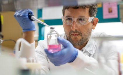 Researcher pipetting liquid in a lab