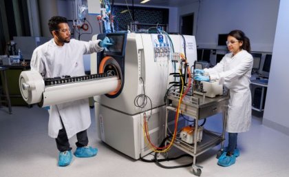 two researchers looking at a large machine