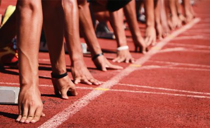 Image: Adobe. Generic image of a sprinters getting ready to start a race on an athletics track.