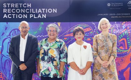 (L-R) UQ Chancellor Peter Varghese, Professor Tracey Bunda, Deputy Vice-Chancellor (Indigenous Engagement) Professor Bronwyn Fredericks & Vice-Chancellor Professor Deborah Terry AC. A man and three women stand on a stage in front of a UQ banner that reads Stretch Reconciliation Action Plan.