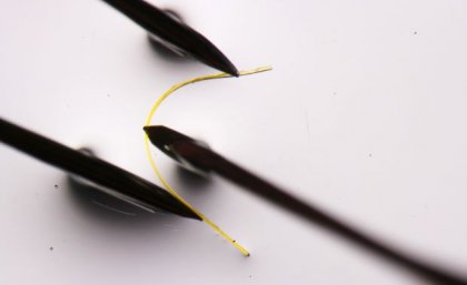 a fine yellow filament is bent between three black points