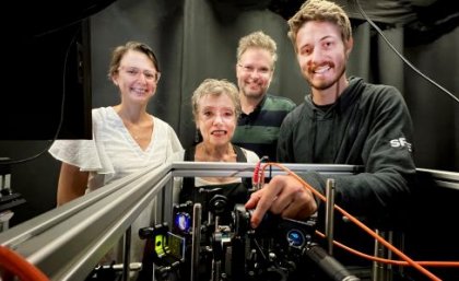 Itia Favre-Bulle, Halina Rubinsztein-Dunlop, Alexander Stilgoe and Mark Watson. Two women and two men stand behind computer equipment