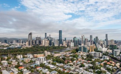 A wide view of a city skyline including high rises and residential housing