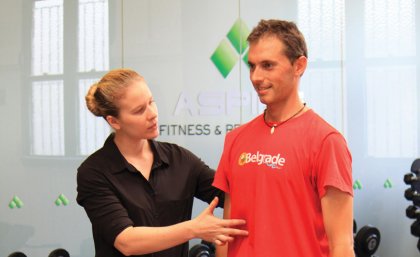 Molly Shevill helps a participant with the exercise program