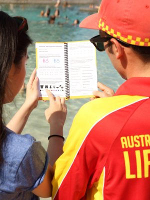 A beachgoer points to the missing person's section 