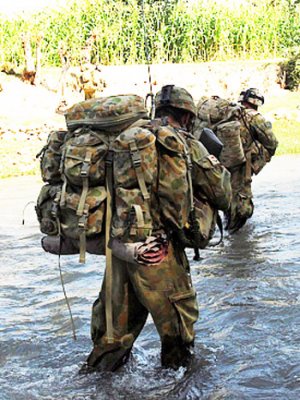 Mentoring and Reconstruction Task Force 2 soldiers cross one of many rivers whilst on patrol through Sorkh Lez in the Mirabad Valley, Southern Afghanistan. Photo by Corporal Rachel Ingram