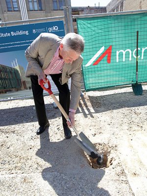 Visionary philanthropist Graeme Wood buries a piece of coal in front of the construction site of the Global Change Institute Living Building at St Lucia