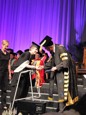 Bridget Harrington stepped out of her wheelchair and walked publicly for the first time in 7 years to collect her award from UQ Chancellor John Story. Bridget Harrington stepped out of her wheelchair and walked publicly for the first time in 7 years to collect her award from UQ Chancellor John Story.