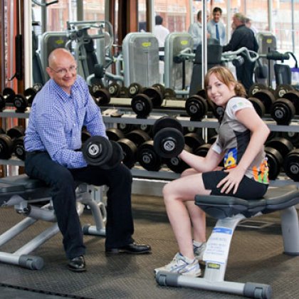 Shayne Neumann MP with UQ student and UQ Sport staff member, Courtney Bailey lifting weights in the new gym.