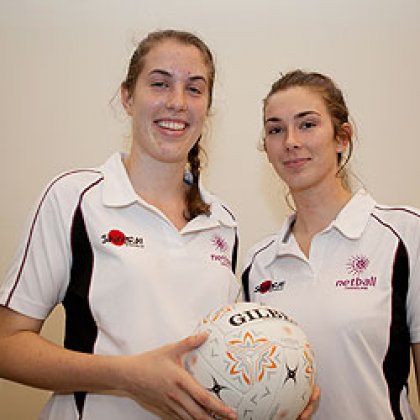 UQ Arts students and rising netball star Laura Clemesha (left) with fellow player Shannon Holmes. Image – Libby Best