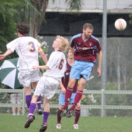 Players deal with a header during last week's Premier Division 1 match between UQFC and The Gap