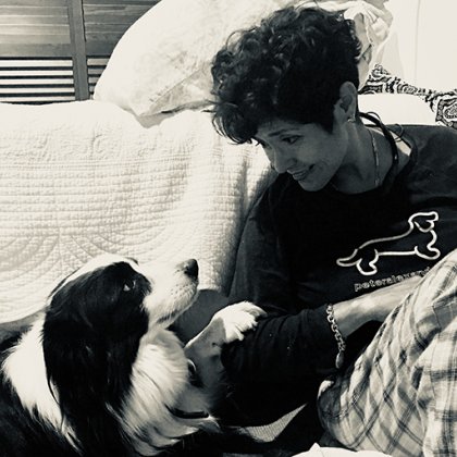 Cancer patient Lucas a Border Collie sits next to his owner Martha Yáñez