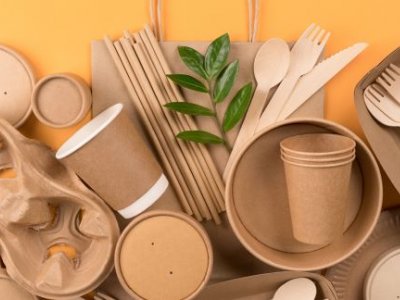 a pile of brown boxes, cups and utensils