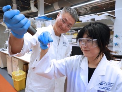 UQ reseachers examining light conversion technology in a lab. 