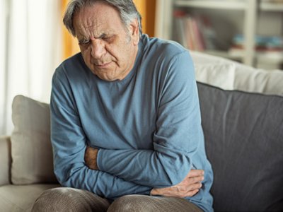 Man holding his lower abdomen in pain