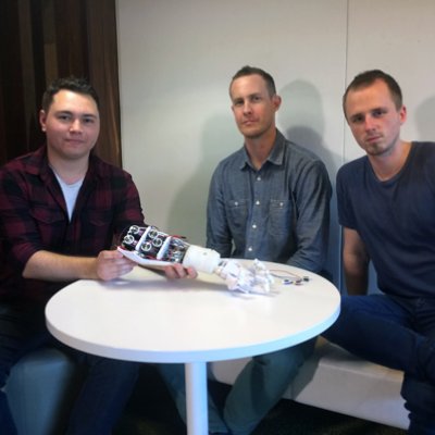 UQ Robotics Club members Fabian Vasuain and Lex Van Cooten with amputee consultant Ben Tarbuck (centre).